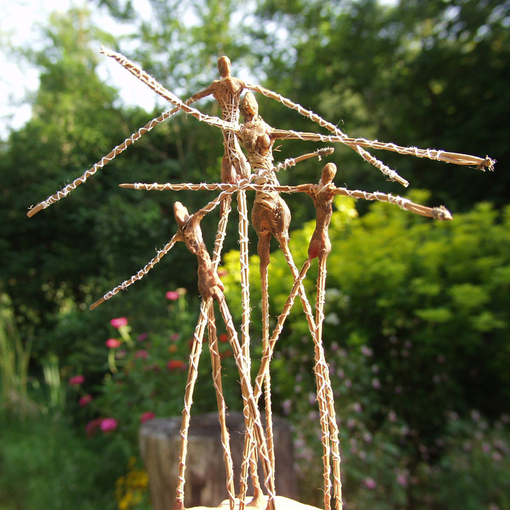 Groupe de personnages en marche. Aiguilles de pin . Sculpture de Philippe Doberset